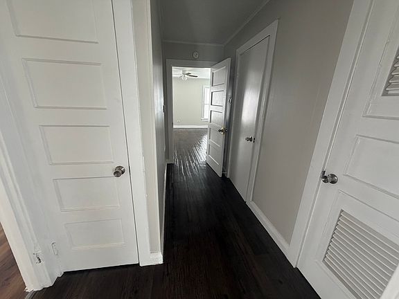 Hallway - view into back bedroom - 1st door (to right) is hotwater heater closet- 2nd door (to right wall) - Bathroom - 1st door (to left) - hall closet