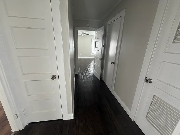 Hallway - view into back bedroom - 1st door (to right) is hotwater heater closet- 2nd door (to right wall) - Bathroom - 1st door (to left) - hall closet