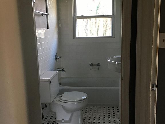 Nice tiled bathroom with large medicine cabinet, exhaust fan