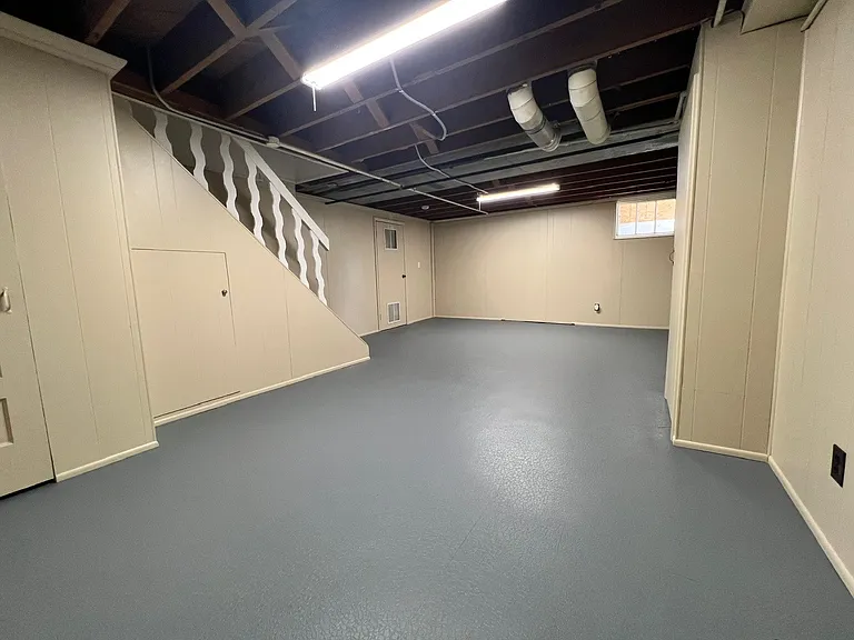 Freshly painted bonus space in basement, perfect for second living room, workout space or home office. There is an extra 1/2 bath on lower level.