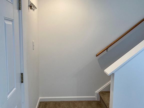 Like new carpeted landing and steps to the upper floor. Well lit.
