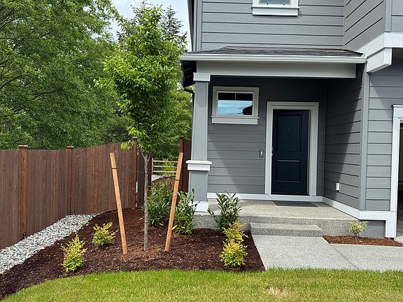 Front door to the left of the 2 car garage.
