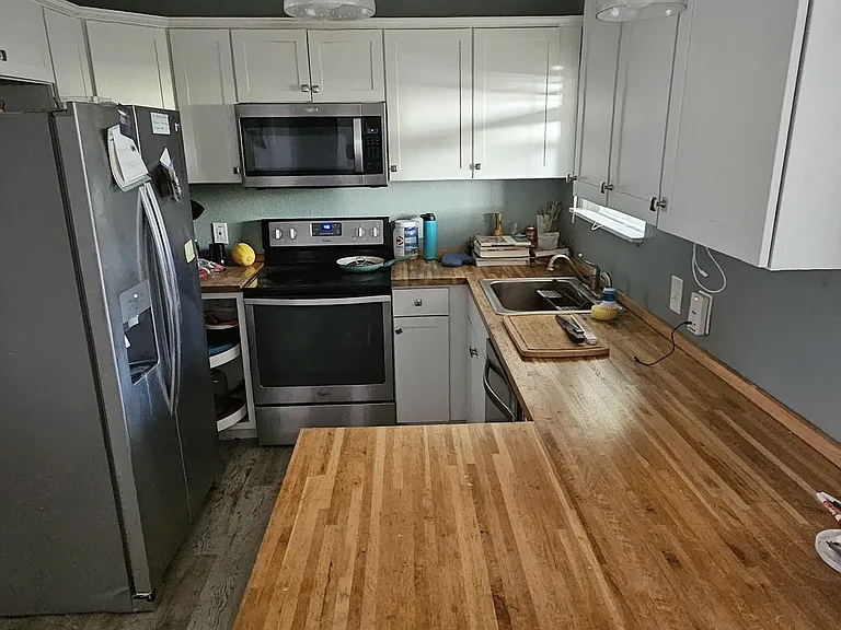 Apt B kitchen includes refrigerator, dishwasher, disposal, range and microwave
