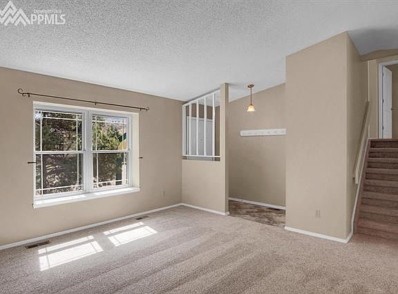 Bright & spacious Living Room has vaulted ceiling & mountain views.