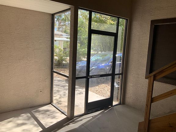 Photo of enclosed private porch looking out into parking area