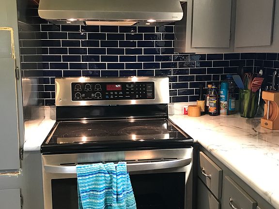 New stove and backsplash. Large kitchen.