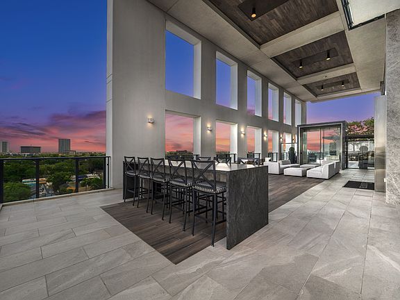 9th floor loggia offering views of downtown Houston and both dining and cozy seating areas