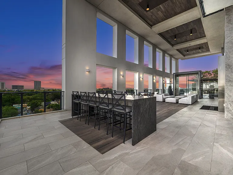 9th floor loggia offering views of downtown Houston and both dining and cozy seating areas