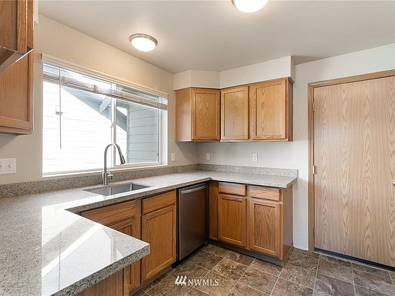 The light-filled kitchen has been tastefully updated with quartz counters & undermount stainless sink. 