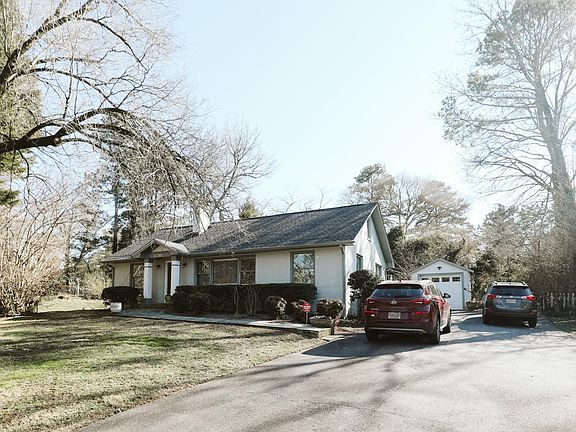 Front of the home, including the driveway.