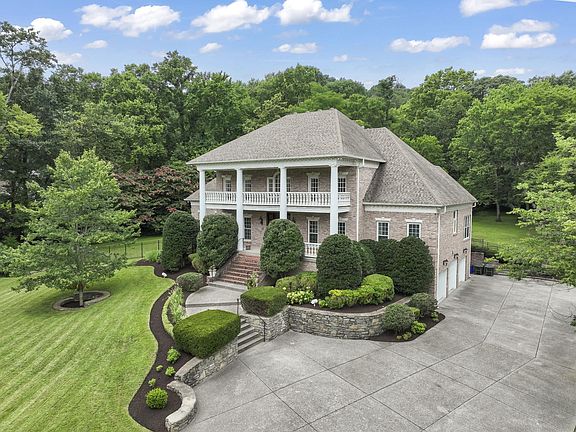 Aerial view with spacious driveway and 3 car garage