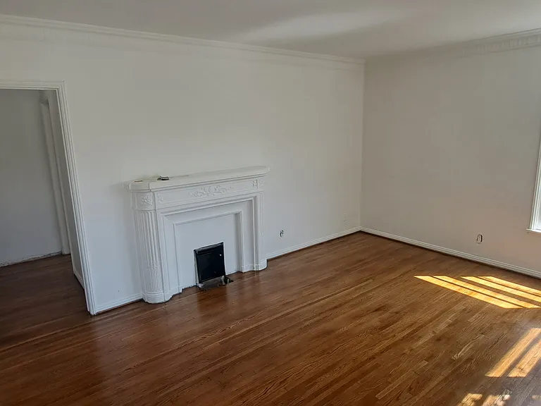 Living room with faux fire place heater, New hardwood floors oak, will have window ac unit with wifi access. Size is 12'x18' sq feet. 

Here is walk through video of the unit: