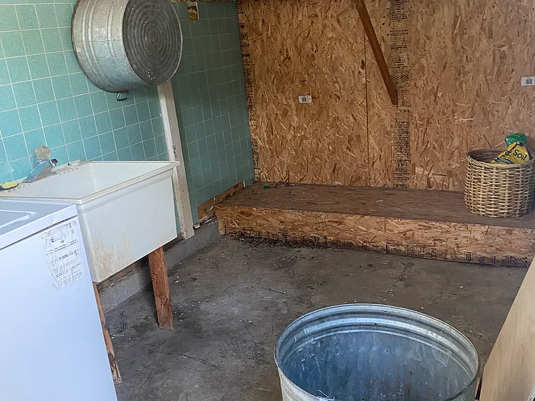 Laundry room with deep sink and storage.