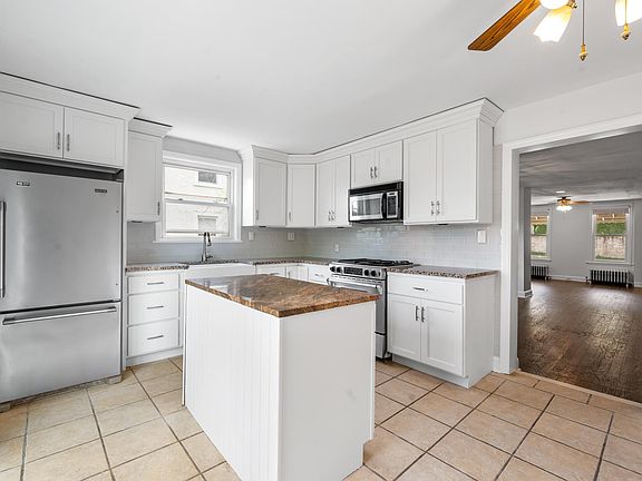 Spacious & Sunny Granite/Stainless Kitchen With Cooking Island and French Doors to Oversized Deck!