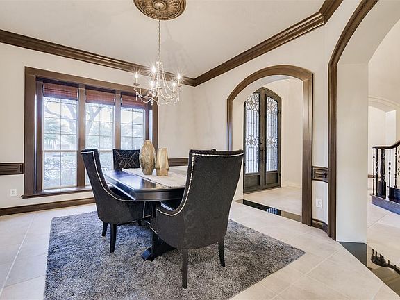 Your Formal Dining with Chair Railing is to your Right as you Enter the Arched Entry from the Foyer. complete with Crown Molding and Large Windows the sparkling Chandelier sets a Festive tone!