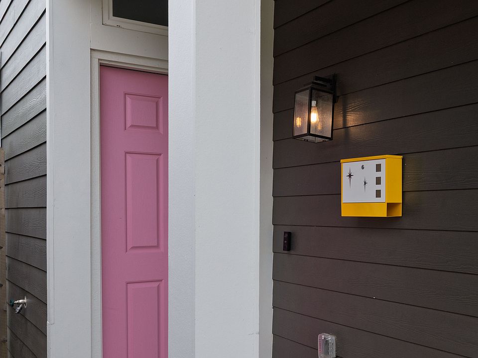 Welcome through a vibrant pink front door that adds a fun, inviting splash of color to your stay!