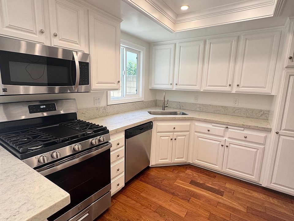 White, bright, fresh kitchen with stainless appliances, including new stove