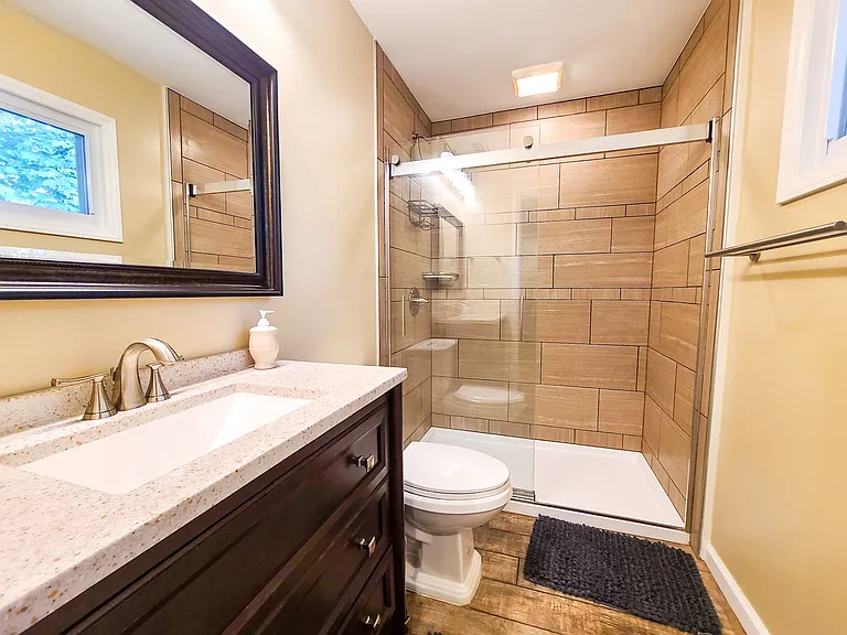 Private bath in master suite. Fully tiled step-in shower. Granite countertop on vanity.