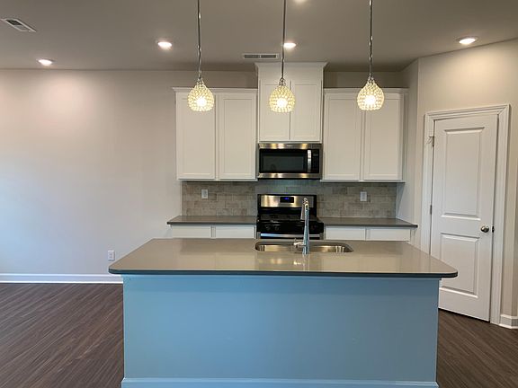 Kitchen with Island, backsplash, stainless steel appliances