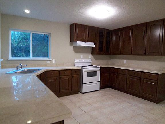 Remodeled kitchen with new cabinets, granite tile countertops and appliances.