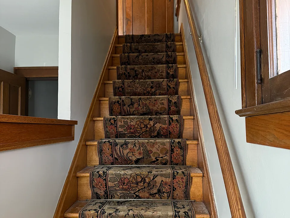 Stairway to the upstairs from the entry hall entrance