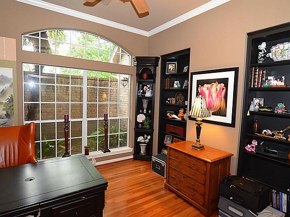 Private Study features Hardwoods, Built-In Cabinets, High Ceilings and View out to Private Atrium.