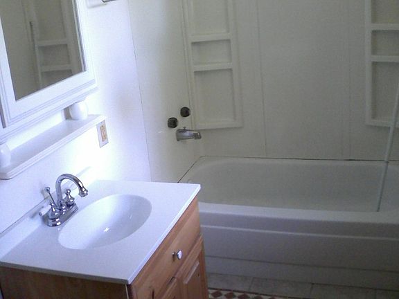 Tub/shower now with glass doors.
