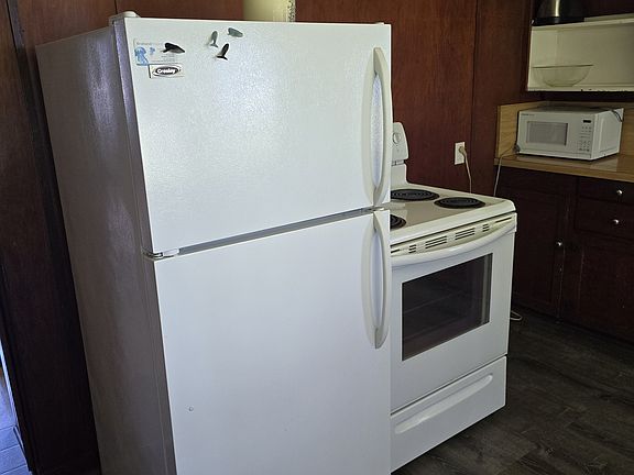 Enjoy the convenience of a full-size refrigerator and a reliable stove, perfect for preparing delicious meals