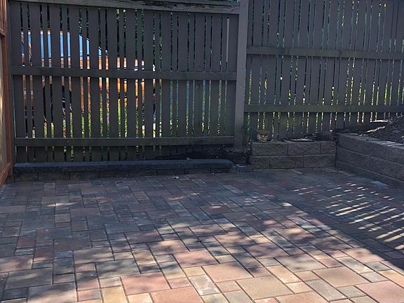 Same front courtyard patio view/ different day. There is parking - one car per unit - just beyond the fence. The property abuts a wall of a blackberry bramble, which adds to the private feel.