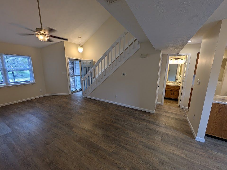 Open concept living area leading to half bath downstairs.