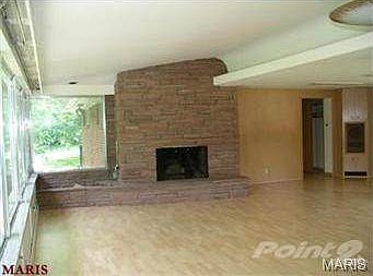 Open floor plan has great room with masonry fireplace