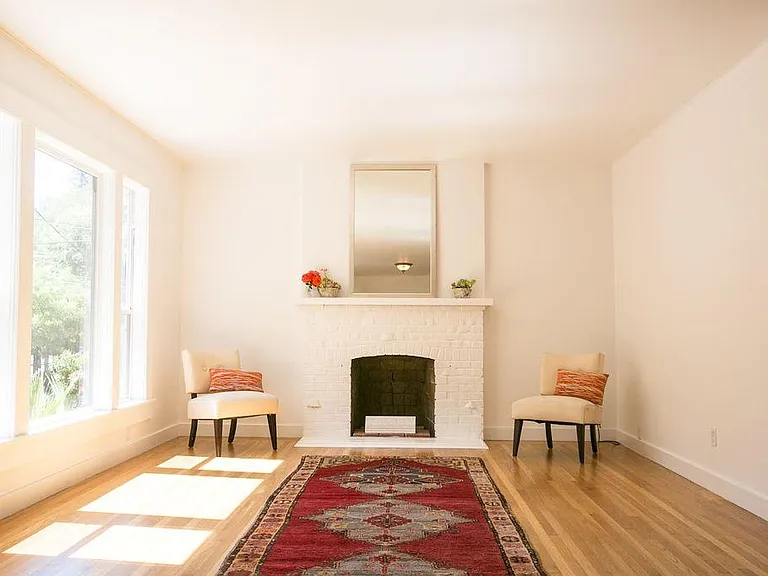 Looking from inside entry toward the fireplace and front window facing street.