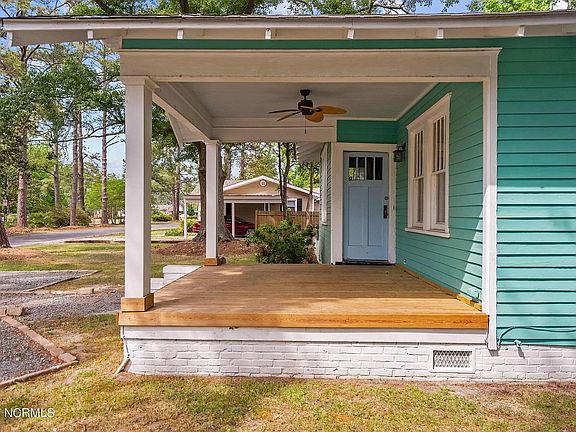 Covered front porch with ceiling fan for relaxing on those cool nights.