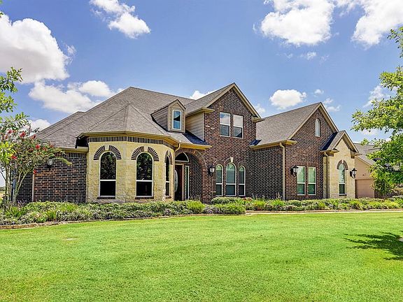 Professionally landscaped, and has 2 ft. of river rock between the home and the flower beds around the entire house with TREX border trim.