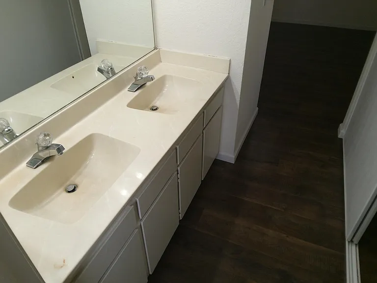 Master Bedroom with Dual Sinks and one of the closets is across from the sinks.