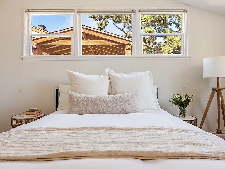 Secondary bedroom with built in closet space and dresser.