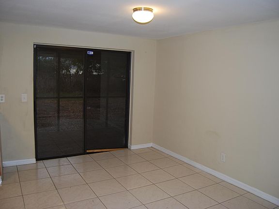 Dining Room with Sliding Glass Doors leading to Screen Enclosure
