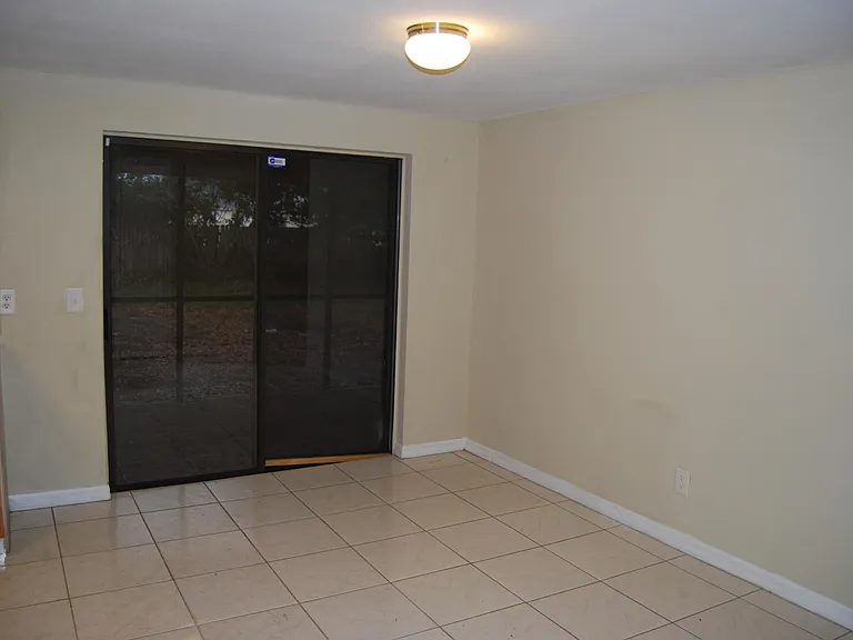 Dining Room with Sliding Glass Doors leading to Screen Enclosure