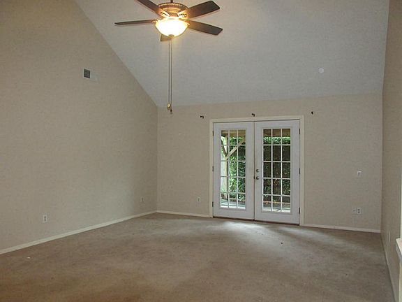 Large living room looking out to nicely covered patio.