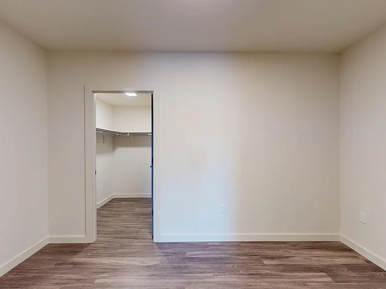 Apartment study with wood-style flooring.