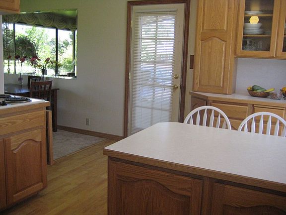 Kitchen- center island gone and fridge, oven, and cabinets to the right of doo