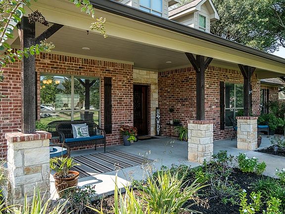 This wonderful ranch style home has a brick and stone elevation, along with dormers, wood shutters and columns!