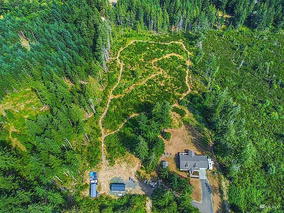 Quietly nestled on a dead-end road, surrounded by lush trees with trails ready for you to roam your property.>