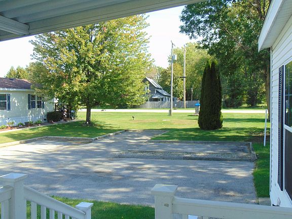 Looking to the East from your front porch you will notice the lovely grounds this home is on.