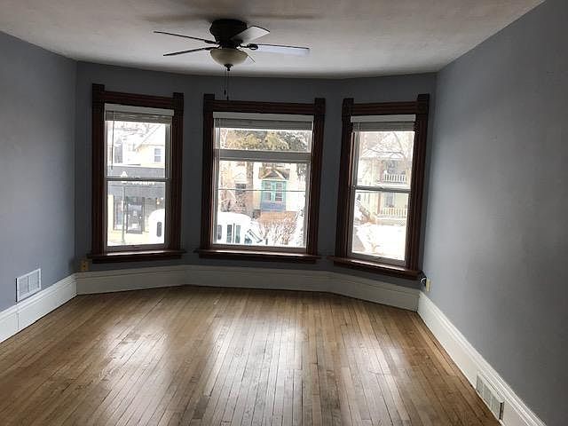 Living room. Original hardwood floors and bay window.