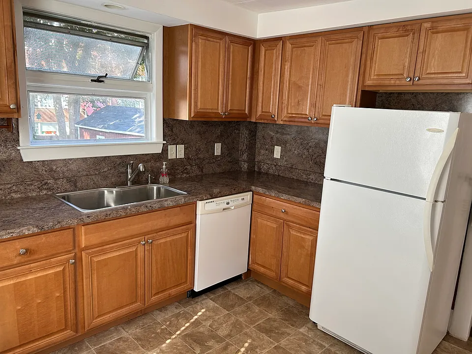 Eat-in kitchen with gas stove, fridge, dishwasher, disposal.