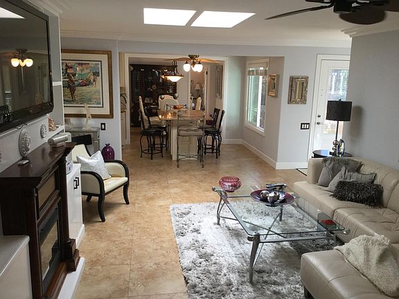 LIVING RM, BRKFST RM/ISLAND AND DINING RM. MAIN ENTRY AT CENTER RIGHT.