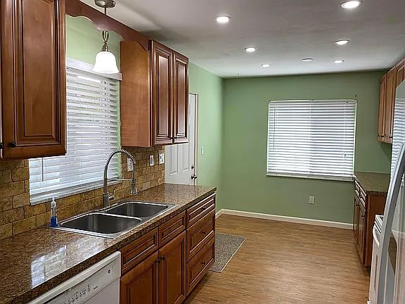 Kitchen with small eating area and rear entrance door (on left)