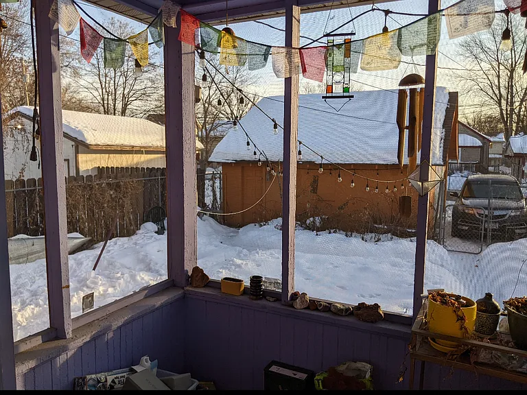 Back porch overlooking garage, yard, and off-street parking