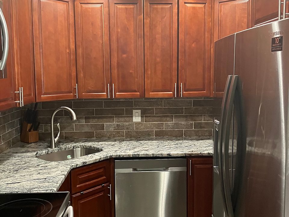 Fully equipped kitchen with granite counter tops, and stainless steel appliances including dishwasher, family sized refrigerator microwave and stove.